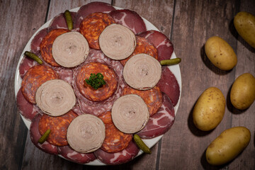 Food tray with delicious salami, pieces of sliced ham, sausage, Deli meats, Pickles, Hight quality photo