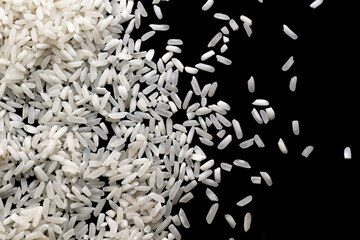 white rice on a black isolated background - obrazy, fototapety, plakaty