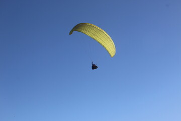 paragliding in the blue sky