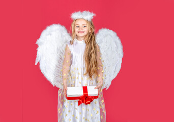 Little kids angel with present gift. Little angel with white wings holds gift. Playful angelic...