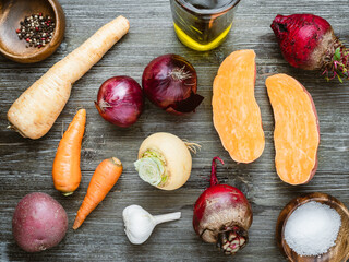 Variety of root vegetables on the kitchen table, ready for cooking.
