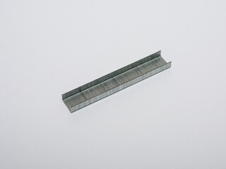 Metal staples insulated on a white background.