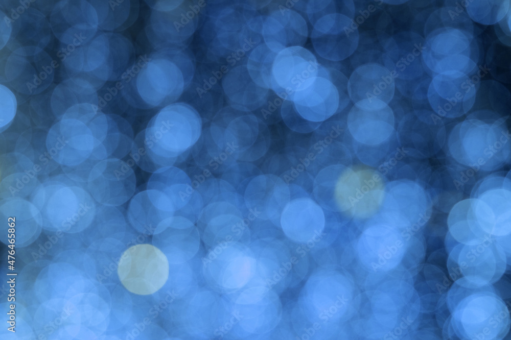 Wall mural abstract bokeh lights in blue. defocused background. blurred bright light. circular points.