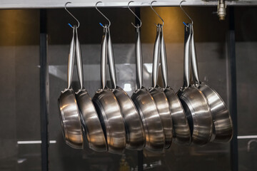 Many pans hanging in a restaurant kitchen.
