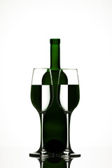 Beautiful bottle with two glasses with inverted reflection on white background