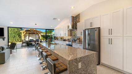 Luxury kitchen with a large granite island - obrazy, fototapety, plakaty