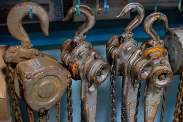 Old rigging hoists hang from hooks in the garage.