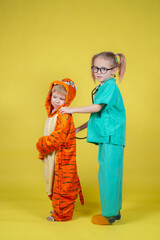 children play doctor, a boy in a tiger costume came to the pediatrician