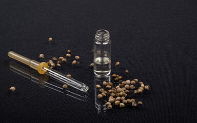 Obraz na płótnie Canvas pipette and glass bottle with hemp oil, essential oil and marijuana seeds