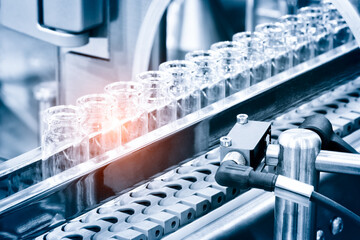 Glass bottles in production in the tray of an automatic liquid dispenser; a line for filling...