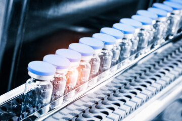 Glass bottles in production in the tray of an automatic liquid dispenser; a line for filling...