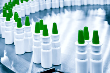 Close-up Many white plastic spray bottles for packaging liquid medicines or cosmetics in a row on a...