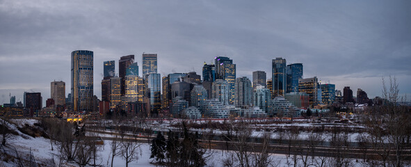 Fototapeta na wymiar Calgary's skyline panorama at sunrise on a cold winter day along the Bow River.