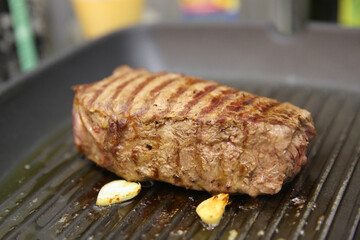 Steak beef meat fried in a grill pan, medium roast meat