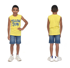 rear view of full portrait of a boy dressed in shorts and sleeveless with arms crossed on white background