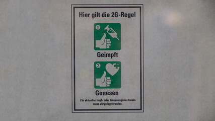 2G Corona warning sign on a store in Germany