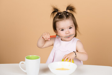 Babies eating, healthy food for a baby. Little baby eating fruit puree.