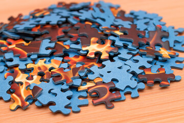 Colorful Peaces of a Mixed Jigsaw Puzzle Lie on the Wooden Table - Strategy and Solving Problem Concept