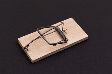 Wooden Mouse Trap. Empty Loaded Mousetrap on Black Background