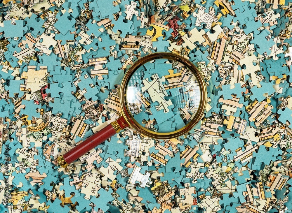 Poster puzzle mess and chaos through magnifying lens. missing jigsaw piece among scattered parts. overflow 