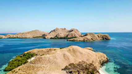 A drone shot of two bigger paradise islands in Komodo National Park, Flores, Indonesia. The islands...