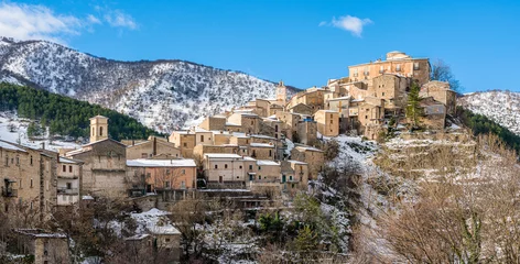 Fototapete The beautiful village of Villalago, covered in snow during winter season. Province of L'Aquila, Abruzzo, Italy. © e55evu