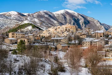 Fototapeten The beautiful village of Villalago, covered in snow during winter season. Province of L'Aquila, Abruzzo, Italy. © e55evu