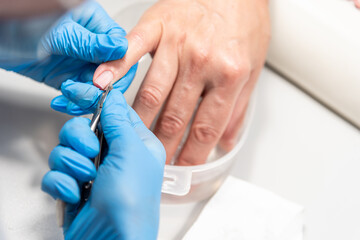 Performing manicure work in a beauty salon.