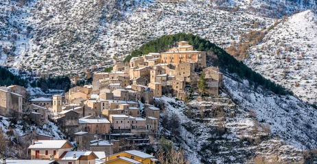 Gordijnen The beautiful village of Villalago, covered in snow during winter season. Province of L'Aquila, Abruzzo, Italy. © e55evu