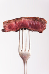 piece of grilled steak on a fork - 476476294