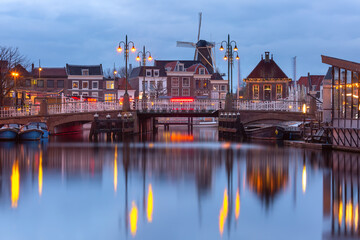 Night Leiden canal with Blauwpoortsbrug bridge and Windmill De Valk, South Holland, Netherlands.