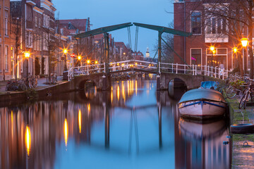 Night Leiden canal Oude Rijn with Kerkbrug bridge, South Holland, Netherlands.
