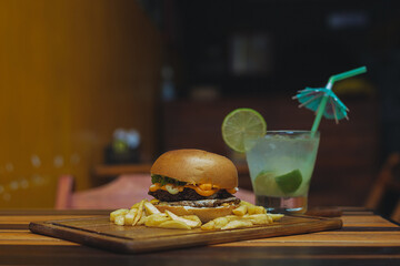 fresh tasty burger
cheeseburger with french fries and glass of cola on wooden table