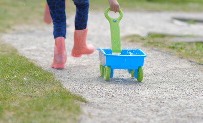 girl running with kart full of water