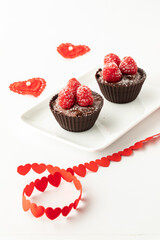 Chocolate raspberry cups with decorations for Valentines Day.