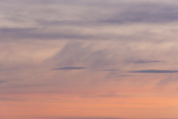 Pink sky with clouds before nightfall.