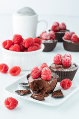 several chocolate raspberry mousse cups against a white background.