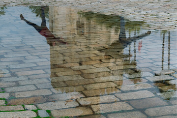 Reflejo de la torre del oro en un charco de agua tras un día de lluvia en Sevilla