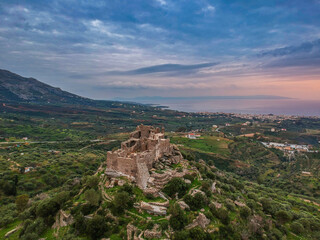 Obraz premium Aerial view of the Castle of Vatika or Castle of Agia Paraskevi at sunset. The castle is located in Mesohori village and has a wonderful view of Neapolis town and Elafonissos island, Laconia, Greece.