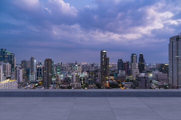 Panoramic Bangkok skyline view, concrete observatory deck on rooftop, night time. Asian corporate...