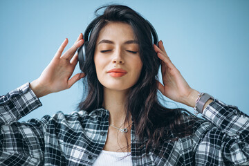 Portrait of a young woman in earphones listening to music