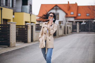 Fototapeta premium Young business woman oitside by the house