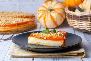 Handmade delicious pumpkin cheesecake and small pumpkins
