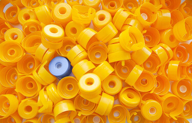 Plastic yellow caps fill the entire frame, one blue among the yellow. Another. Stand out.