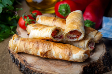 Turkish Pacanga Boregi with pastirma (pastrami) and cheddar (melted) cheese. - Pastirmali Borek