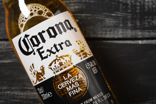 Ternopil, Ukraine - December 22, 2021: A bottle of Corona Extra beer on a wooden background with copy space