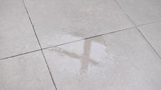 Water drips onto the tiled floor.
