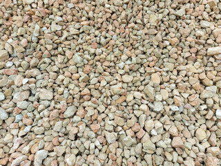 Multi-colored pebbles, medium-sized stones. Close-up view from above.
