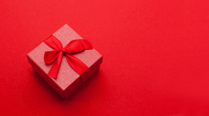 red gift box on a red background with a place for text
