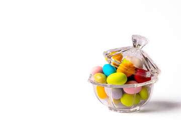 Colorful almond candies in the stylish,crystal candy bowl on white with copy space.The Sugar Feast concept. (Turkish name; Ramadan - Ramazan bayrami, Seker bayrami)